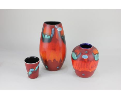 Two Poole pottery vases, with abstract decoration in blue, green, orange and black on red ground, tallest 25.5cm, together wi