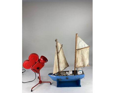 A scratch built model of a two-masted sailing boat, on blue painted stand, 54cm high including stand, a novelty red metal tab