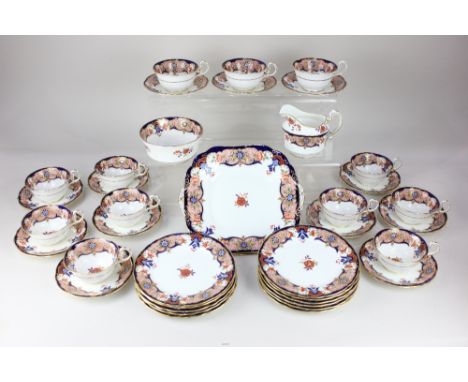 An Aynsley porcelain part tea service, with floral decoration in the Imari palette, and gilt embellishments, comprising milk 