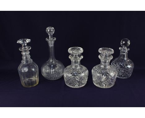 A pair of glass spirit decanters, a globe and shaft decanter, and two others