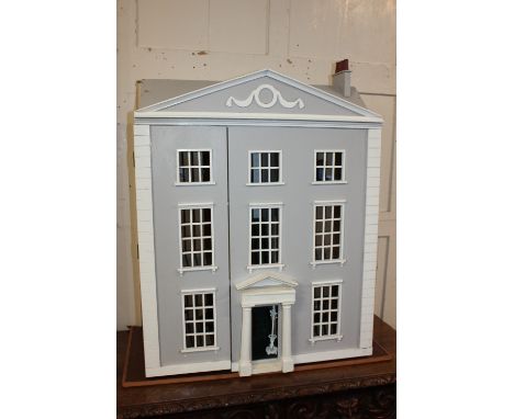 A modern Regency style three storey doll's house, with white and grey painted facade, and hinged front, 89cm high, together w