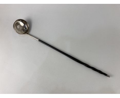 A toddy ladle, with George II 1758 shilling inset, whalebone handle, white metal unmarked