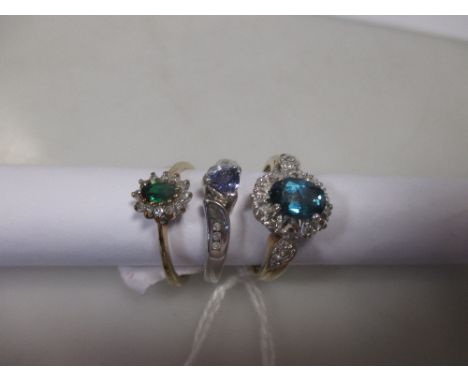 A blue topaz and diamond cluster ring 9ct London convention marked, A tsavorite and diamond cluster ring 9ct London 1994 and 