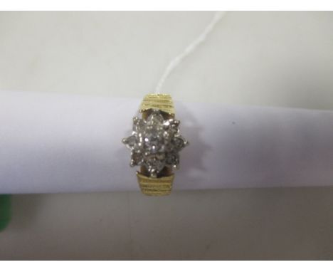 A diamond cluster ring set in hallmarked 18ct gold, Sheffield 1975  