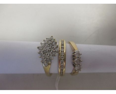 A modern diamond cluster ring 9ct London convention marked, a 3 stone diamond ring 9ct Sheffield convention marked and stampe