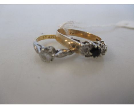 An single stone diamond ring and a 9ct sapphire and diamond three stone ring, the 'round brilliant' cut diamond of approximat