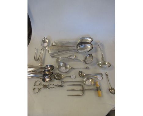 A collection of silver flatware including five tablespoons, two toddy ladles, a pierced ladle, thirteen teaspoons, a caddy sp