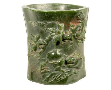 A CHINESE SPANISH GREEN JADE BRUSH POT of naturalistic form with chinese script13cm high 12cm wide 