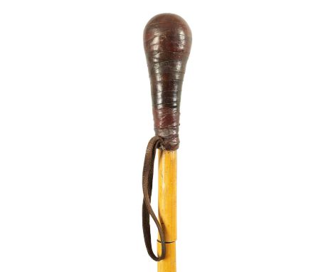 AN EARLY 20TH CENTURY BAMBOO AND LEATHER DAGGER STICK the leather bound handle on a bamboo stick concealing a tapering trifor