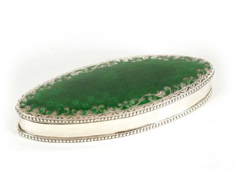AN EDWARD VII SILVER AND CHEQUERBOARD PATTERN GUILLOCHE ENAMEL ECLIPSE SHAPED BOX with engraved scrolling floral decoration a