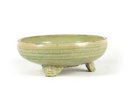 AN EARLY CELADON MING DYNASTY TRIPOD BULB BOWL of ribbed outline, raised on a mask head tripod base.30.5cm diameter 11.5cm hi