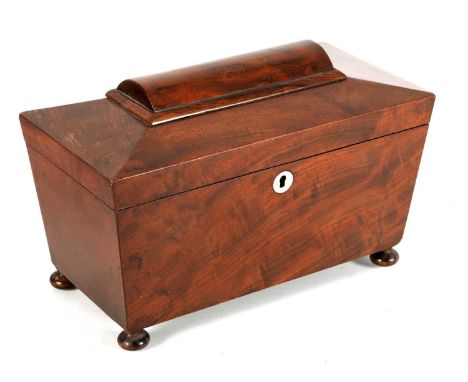A LATE REGENCY MAHOGANY SARCOPHAGUS TEA CADDY with a rounded panelled top above a fitted interior of double compartments and 