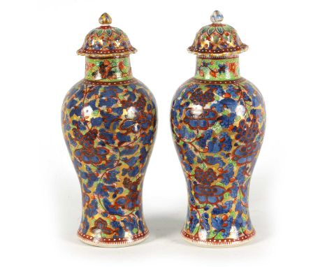 A PAIR OF CHINESE KANGXI PERIOD INVERTED BALUSTER VASES AND COVERS with 19th century colourful all-over polychrome decoration