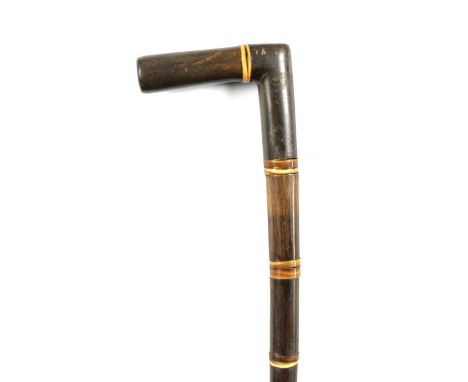 A 19TH CENTURY SEGMENTED RHINOCEROS HORN WALKING STICK made up of eighteen pieces of tapered horn78.5cm overall