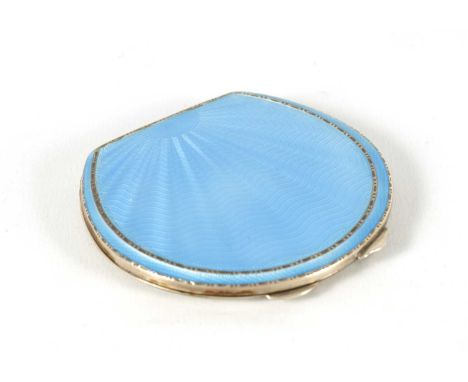 A GEORGE VI SILVER AND GUILLOCHE ENAMEL HORSESHOE SHAPED COMPACT with sunburst design opening to reveal a mirror and powder c