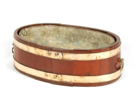 A GEORGIAN OVAL COOPERED BRASS BOUND WALNUT PLANTER/WINE COOLER with axe drop side handles and lift out liner56cm wide 32cm d