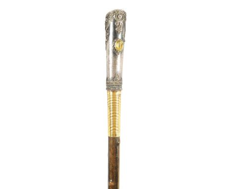 AN EARLY 20TH CENTURY RHINOCEROS HORN SWAGGER STICK having a jewelled silvered metal handle with silver and gold filligree de