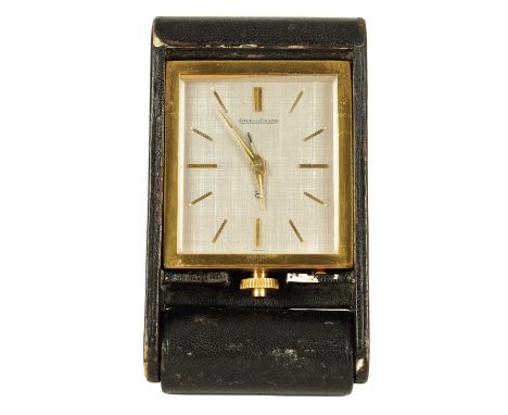 A MID 20TH CENTURY JAEGER LE COULTRE TRAVELLING ALARM CLOCK with leather case and number 106140, the rectangular case with si