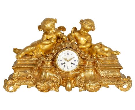 A LARGE 19TH CENTURY FRENCH FIGURAL ORMOLU MANTEL CLOCK surmounted by two cherubs on a leaf work base with floral swags enclo