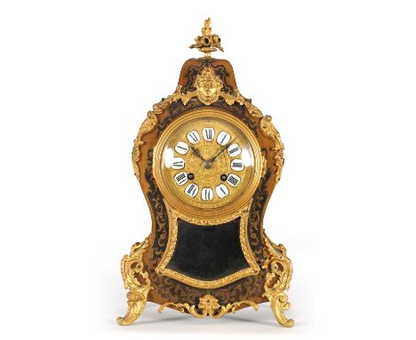 A LATE 19TH CENTURY FRENCH EBONISED AND BOULLWORK MANTEL CLOCK of typical shouldered tapering form on leafcast splay feet, th