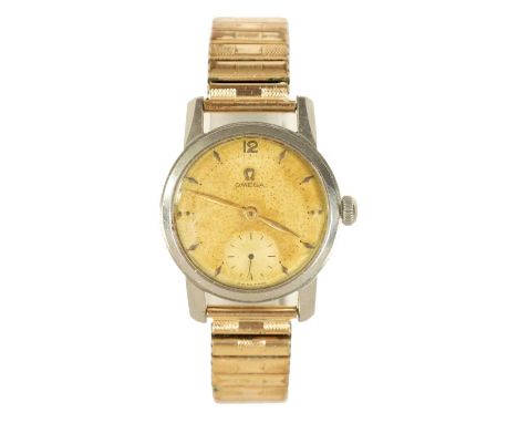 A GENTLEMAN’S 1950’s STEEL OMEGA WRIST WATCH on later bracelet, the discoloured champagne dial with diamond shaped hour marke