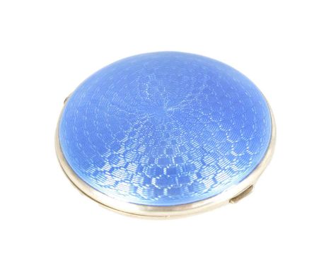 A GEORGE V SILVER AND GUILLOCHE ENAMEL CIRCULAR POWDER COMPACT with geometric blue enamel pattern to the lid revealing a mirr