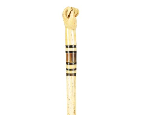 A 19TH CENTURY WHALEBONE AND BALEEN BANDED WALKING STICK with sailors fist handle and tapering shaft.80cm overall 