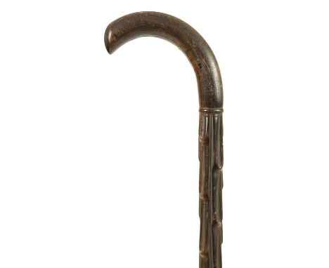 A GOOD 19TH CENTURY RHINOCEROS HORN WALKING STICK with carved branchwork shaft and curved handle.91.5cm overall. 