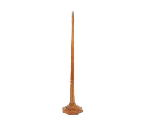A MOUSEMAN STYLE AZED OAK STANDARD LAMP with tapering facetted stem and stepped octagonal base143cm high plus fitting 