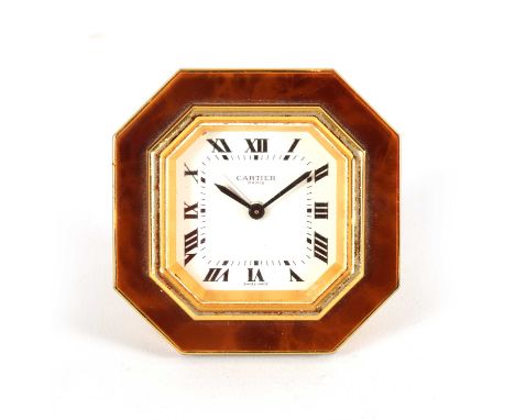 A VINTAGE CARTIER OCTAGONAL GILT AND ENAMEL DESK CLOCK with winding movement with alarm function, and jewel cabochon adjustin