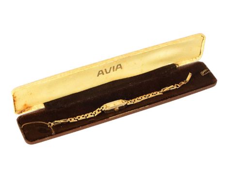 A LADIES 9CT GOLD AVIA VINTAGE WRIST WATCH The tank-shaped case with champagne dial fronting a jewelled manual wound movement