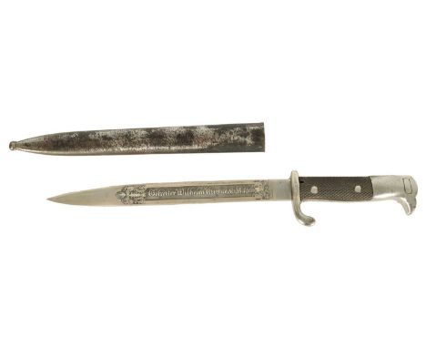 A WWI GERMAN PRESENTATION BAYONET with a "bird's head" style pommel and chequered grips, the blade spine bears etched maker's