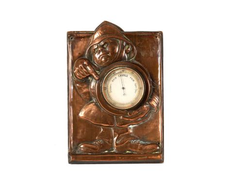 AN ARTS AND CRAFTS COPPER NOVELTY DESK BAROMETER DEPICTING A FIREMAN designed by John Hassel, enclosing an aneroid barometer.