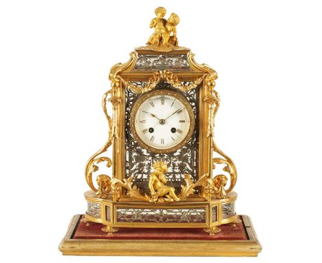 A LATE 19TH CENTURY FRENCH GLAZED ORMOLU MANTEL CLOCK The case surmounted by two ormolu cherubs above a glazed bell top pedim