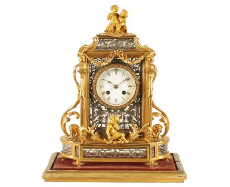 A LATE 19TH CENTURY FRENCH GLAZED ORMOLU MANTEL CLOCK The case surmounted by two ormolu cherubs above a glazed bell top pedim