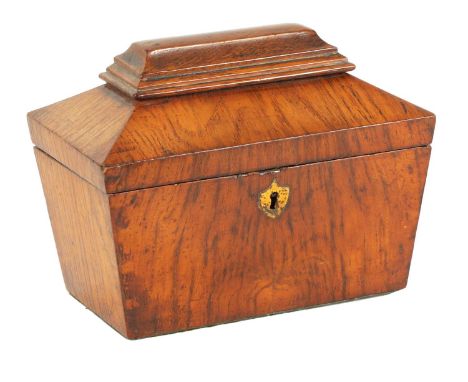 A LATE REGENCY FIGURED OAK SARCOPHAGUS SHAPED TEA CADDY with inlaid burr maple lidded divided interior23cm wide 14cm deep 17.
