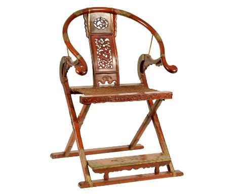 A 19TH CENTURY HORSESHOE BACK FOLDING HUNTING CHAIR POSSIBLY HUANGHUALI having curved top rail without scrolling arms above a