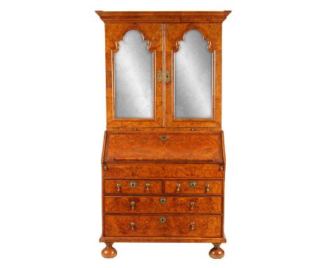 A WILLIAM AND MARY BURR WALNUT BUREAU BOOKCASE the cross-grain moulded upper part with projecting cornice above a pair of sha