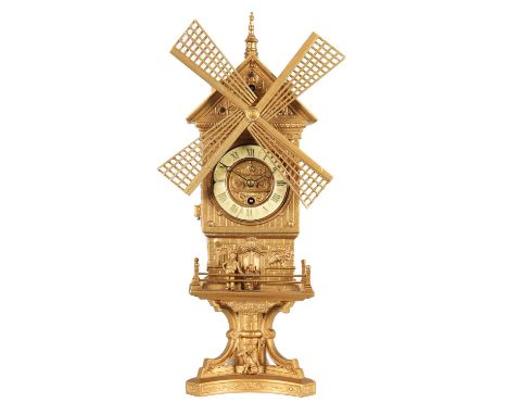 A LATE 19TH CENTURY FRENCH AUTOMATION WINDMILL CLOCK The gilt metal case modelled as a Dutch windmill with figures and a dog 