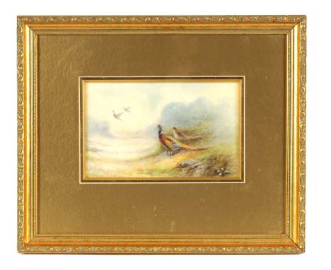 JAMES STINTON. A ROYAL WORCESTER FRAMED RECTANGULAR PORCELAIN PLAQUE painted with a pair of pheasants on the edge of a misty 