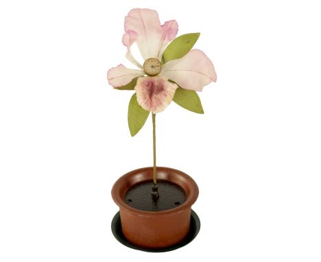 A VINTAGE NOVELTY FLOWER CLOCK modelled as an orchid with watch dial linked to a spring-driven movement housed in a flower po