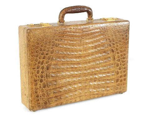 A GOOD VINTAGE CROCODILE BRIEFCASE with fitted document slots to the interior and double gilt brass combination locks.45.5cm 