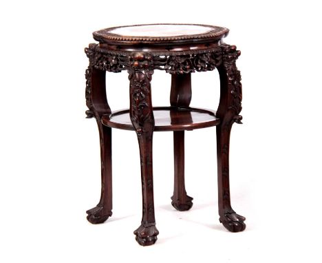 A 19TH CENTURY PROFUSELY CARVED CHINESE HARDWOOD CIRCULAR JARDINIERE STAND with marble inset top and pierced floral work frie