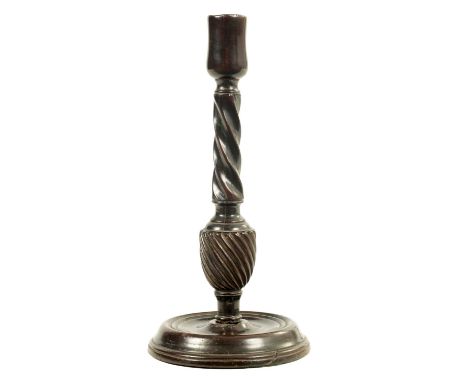 AN 18TH CENTURY MAHOGANY CANDLESTICK with twisted stem and dished ring turned base.27cm high