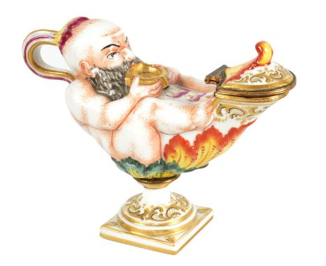 A 19TH CENTURY ITALIAN CAPODIMONTE PORCELAIN INKWELL modelled as a genie and lamp, gilt and hand painted with loop handle and