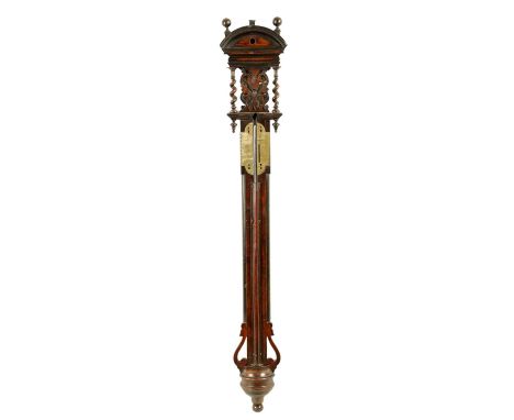 A WILLIAM AND MARY WALNUT STICK BAROMETER of elaborate form with arched pediment above a pierced fret-cut top flanked by barl