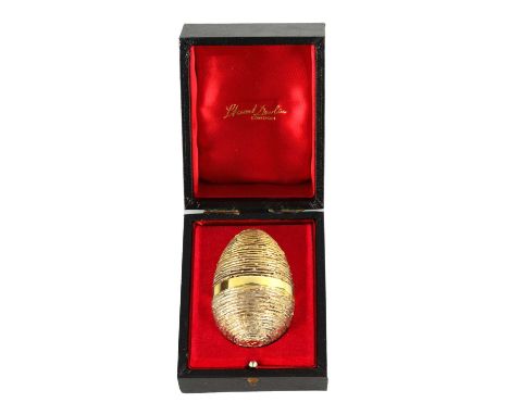 A 1991 STUART DEVLIN SILVER GILT NOVELTY EGG the textured body with a plain girdle opening to reveal two enamelled butterflie
