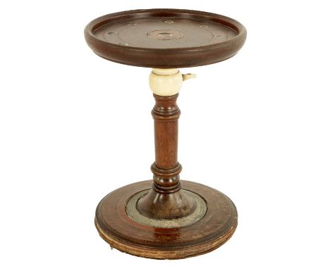 AN 18TH CENTURY MAHOGANY ADJUSTABLE CANDLE STAND with inlaid ivory decorated top and turned stem with thumb screw adjuster, o