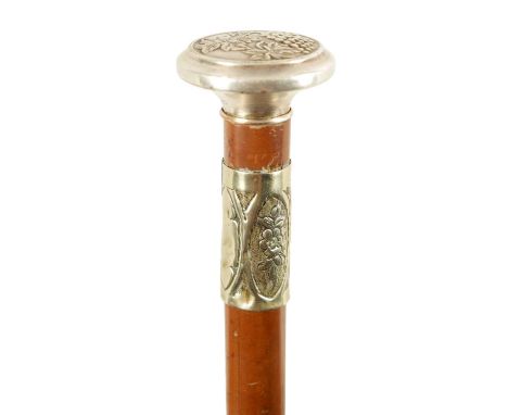 AN ART NOUVEAU MALACCA AND SILVER METAL SWORD STICK the handle embossed with grapes on a vine and malacca cane enclosing a tr