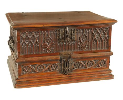 A 16TH/17TH CENTURY SPANISH WALNUT GOTHIC TABLE CABINET the moulded edge hinged top with iron metal fittings and elaborate lo